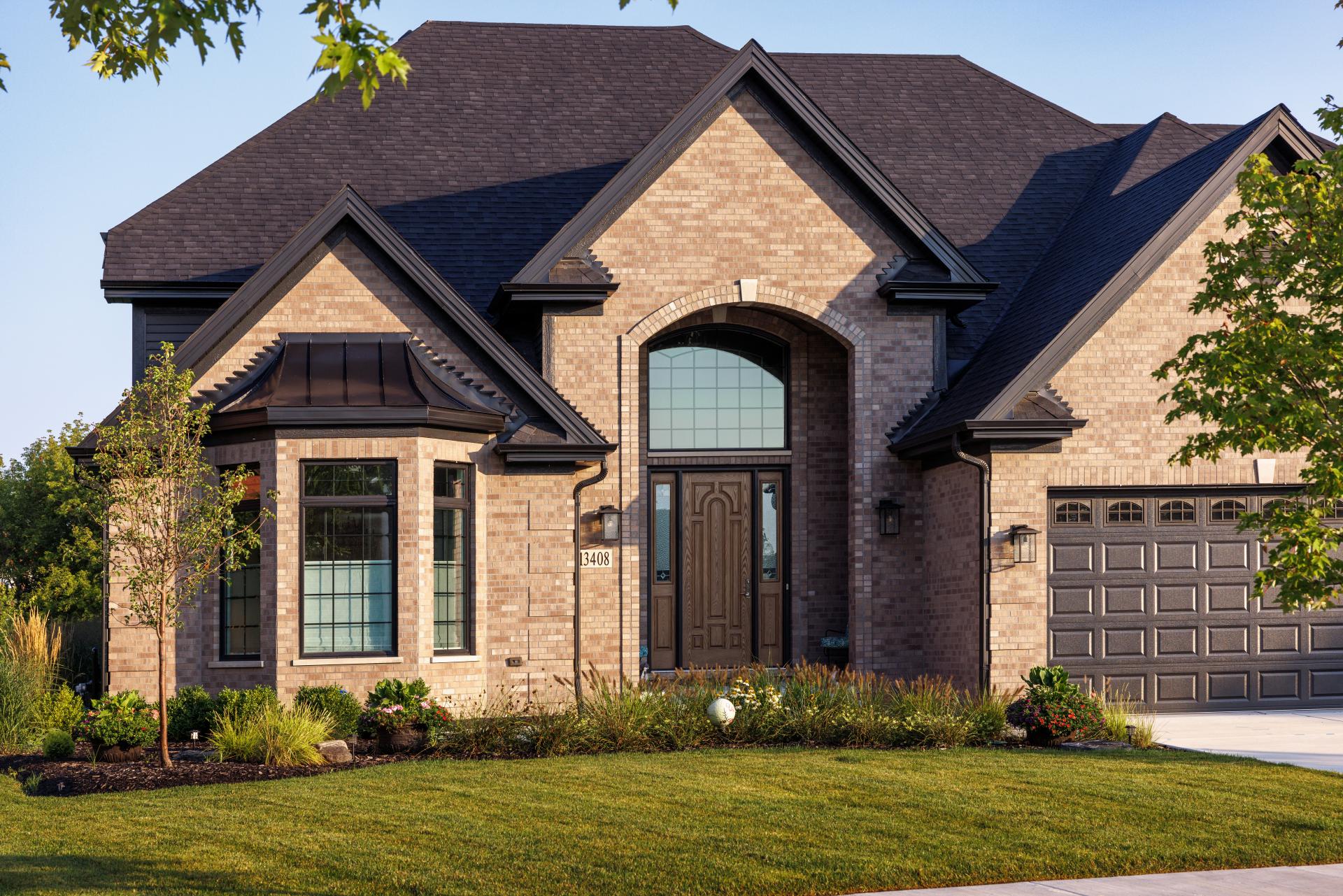tan custom brick home with black accents